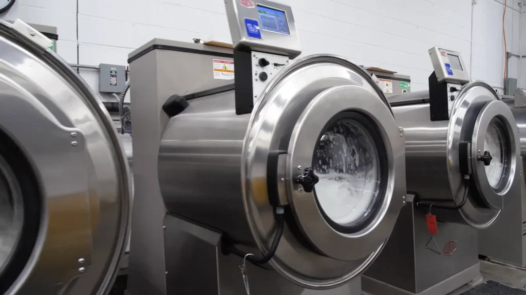 Image of commercial washing machines cleaning linens as part of the tablecloth cleaning service